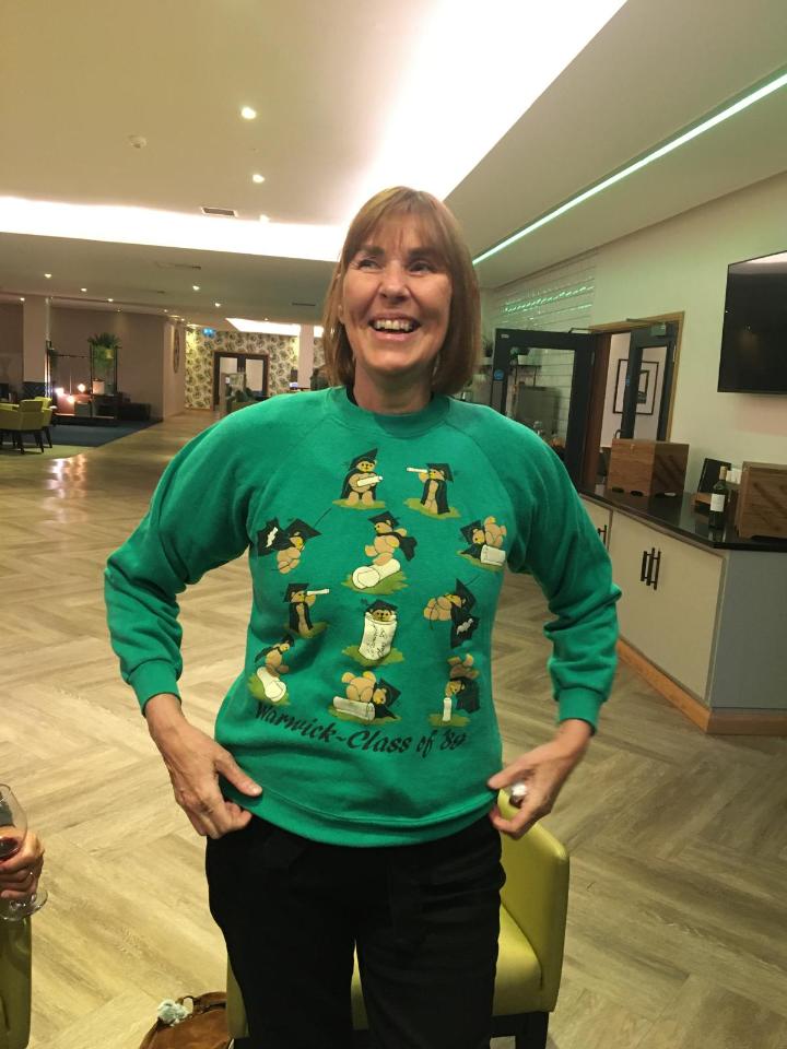 Julie wears a green, graduating in 1989 jumper